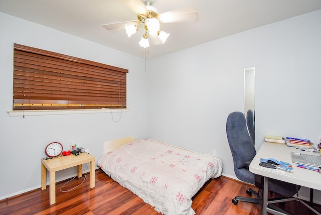 bedroom featuring wood finished floors, baseboards, and ceiling fan