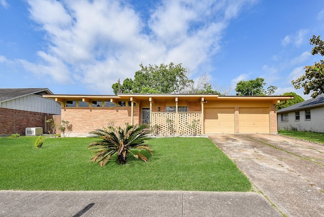 ranch-style home with driveway, brick siding, an attached garage, and a front yard