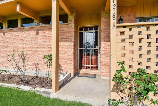 entrance to property with brick siding