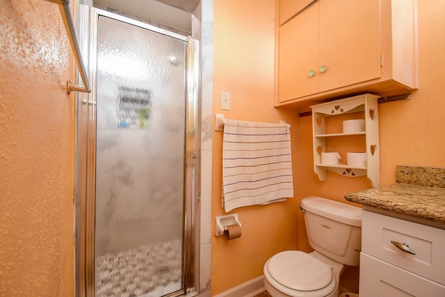 full bath with a stall shower, vanity, and toilet
