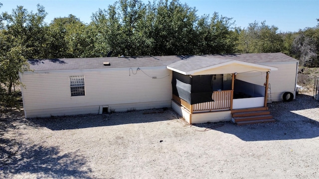 view of front facade featuring a porch, crawl space, and roof with shingles