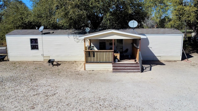 back of property featuring covered porch