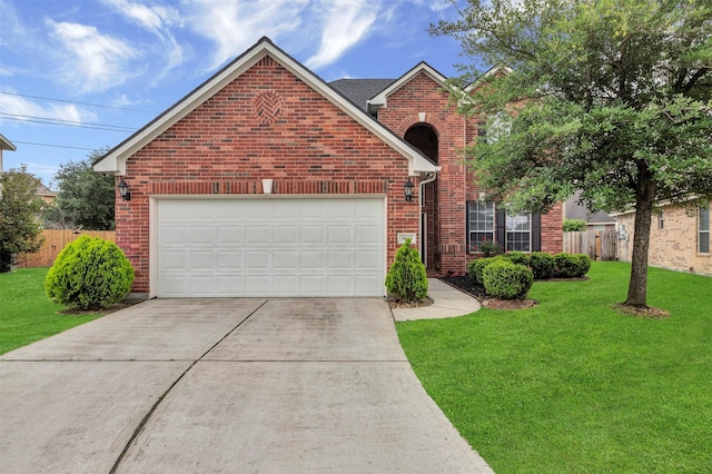 traditional-style house featuring driveway, a front yard, brick siding, fence, and an attached garage