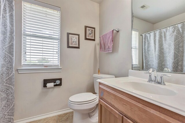 full bath with visible vents, tile patterned flooring, vanity, baseboards, and toilet