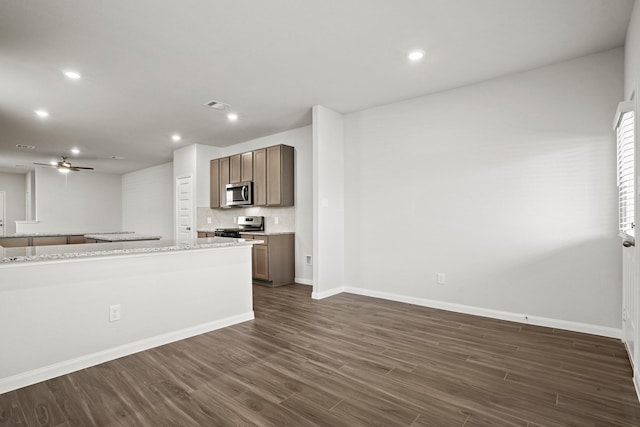 2340 Mooneye Ct, Conroe, TX 77384 - kitchen with dark wood-style flooring, ceiling fan, appliances with stainless steel finishes, recessed lighting, and baseboards