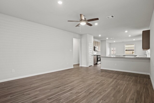 2340 Mooneye Ct, Conroe, TX 77384 - unfurnished living room featuring a ceiling fan, visible vents, baseboards, dark wood-style floors, and recessed lighting