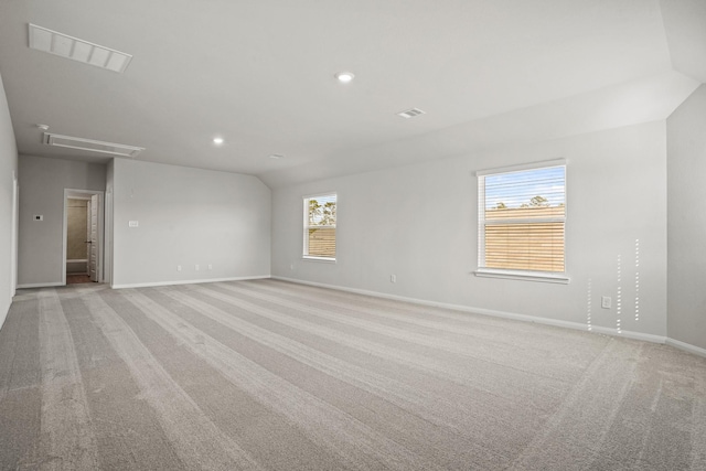2340 Mooneye Ct, Conroe, TX 77384 - unfurnished room featuring visible vents, lofted ceiling, baseboards, attic access, and light colored carpet