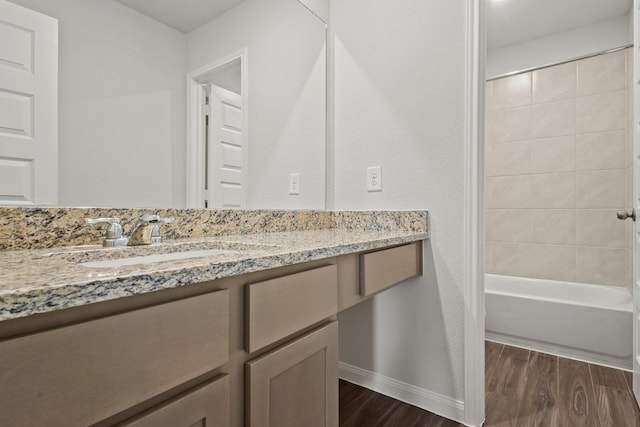 2340 Mooneye Ct, Conroe, TX 77384 - bathroom with baseboards, shower / bath combination, wood finished floors, and vanity