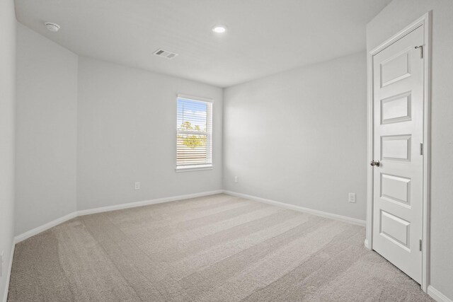 2340 Mooneye Ct, Conroe, TX 77384 - spare room featuring visible vents, baseboards, and light carpet