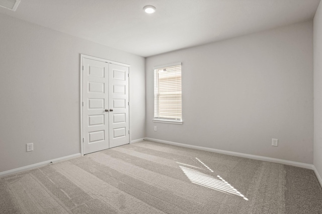 2340 Mooneye Ct, Conroe, TX 77384 - unfurnished bedroom featuring carpet flooring, baseboards, and a closet