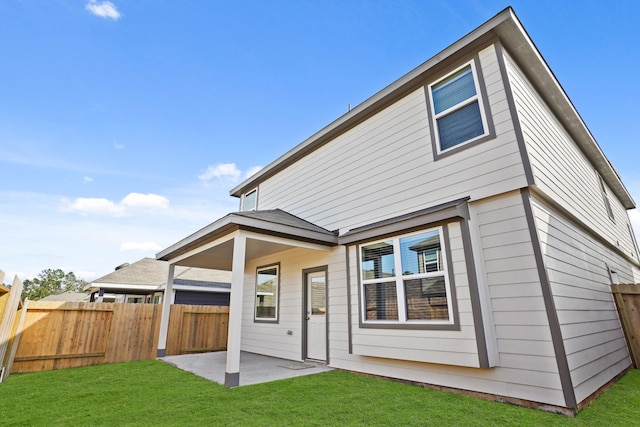 2340 Mooneye Ct, Conroe, TX 77384 - back of house with fence, a patio, and a lawn