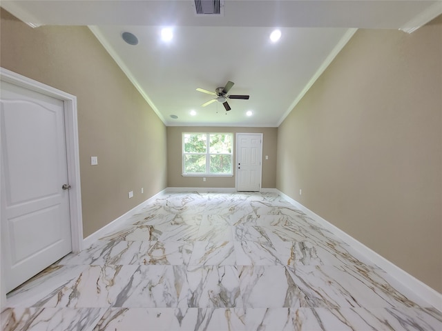 unfurnished room featuring crown molding, a ceiling fan, baseboards, and visible vents
