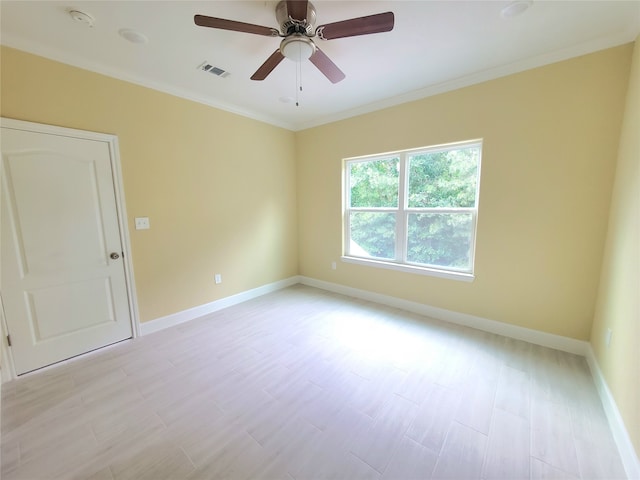 unfurnished room with baseboards, visible vents, ornamental molding, and light wood-style flooring
