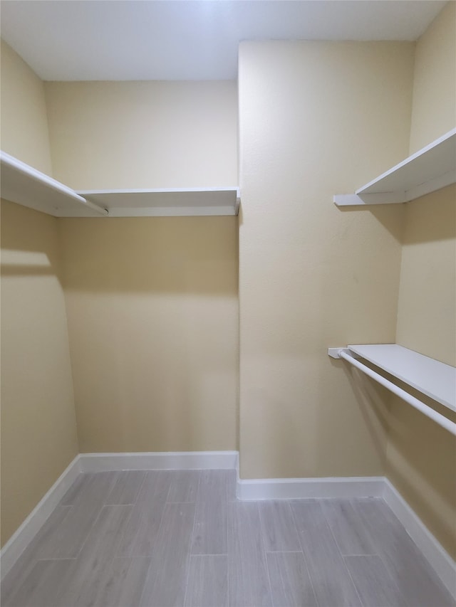 walk in closet featuring wood tiled floor