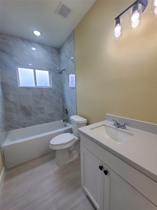 bathroom featuring visible vents, bathtub / shower combination, toilet, and vanity