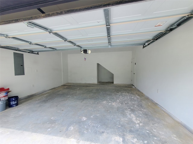 garage with a garage door opener and electric panel