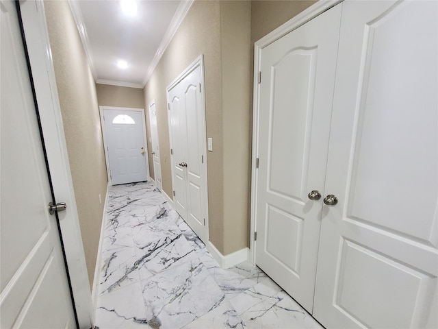 doorway with baseboards, ornamental molding, and marble finish floor