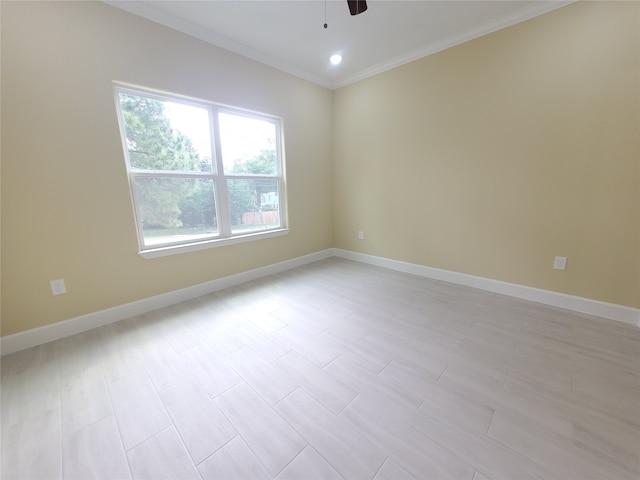 empty room featuring ceiling fan, ornamental molding, and baseboards
