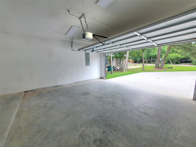 garage featuring a storage unit, a garage door opener, and electric panel