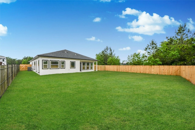 600 Rd 5105, Cleveland, TX 77327 - back of property with a lawn, a shingled roof, and a fenced backyard