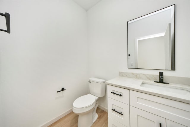600 Rd 5105, Cleveland, TX 77327 - bathroom with toilet, baseboards, wood finished floors, and vanity