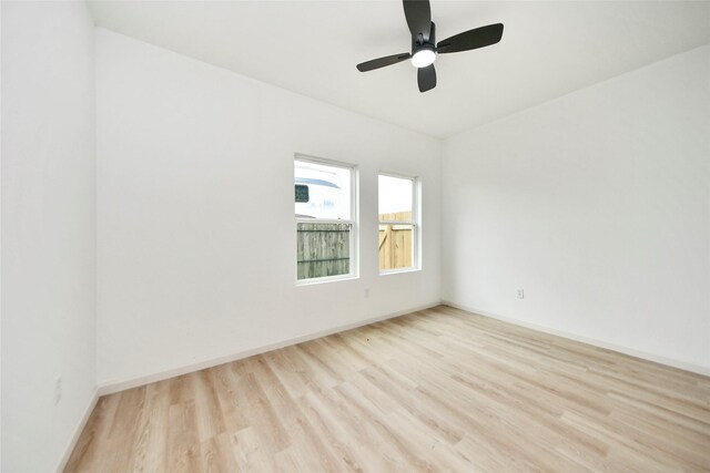 600 Rd 5105, Cleveland, TX 77327 - spare room featuring baseboards, ceiling fan, and light wood-style floors
