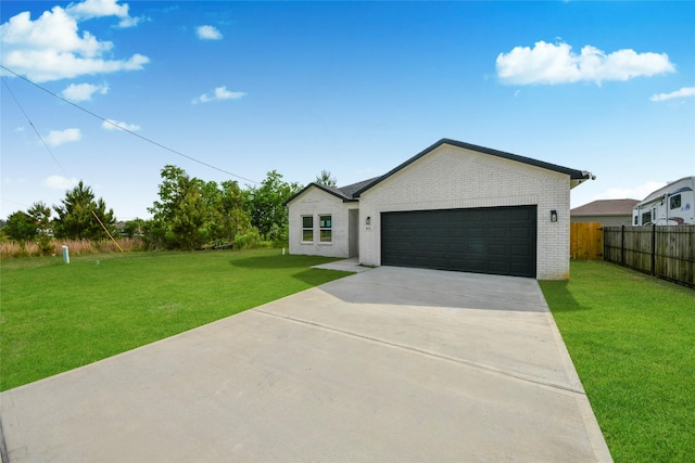 600 Rd 5105, Cleveland, TX 77327 - view of front of home featuring fence, an attached garage, a front lawn, brick siding, and concrete driveway