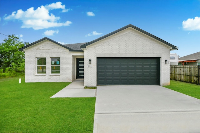 600 Rd 5105, Cleveland, TX 77327 - view of front facade featuring brick siding, fence, a front lawn, concrete driveway, and an attached garage