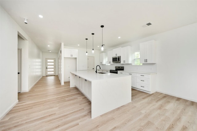 600 Rd 5105, Cleveland, TX 77327 - kitchen featuring white cabinets, appliances with stainless steel finishes, a sink, and light wood-style floors