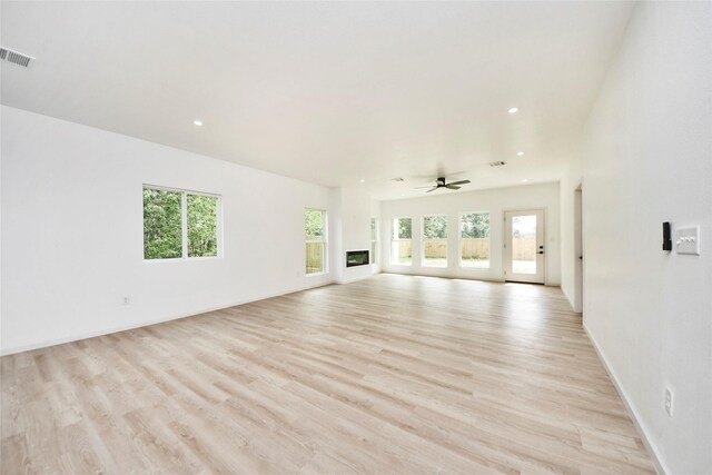 600 Rd 5105, Cleveland, TX 77327 - unfurnished living room featuring visible vents, baseboards, recessed lighting, a ceiling fan, and light wood finished floors