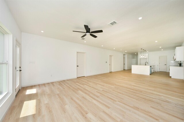 600 Rd 5105, Cleveland, TX 77327 - unfurnished living room with ceiling fan, visible vents, light wood-type flooring, a sink, and recessed lighting
