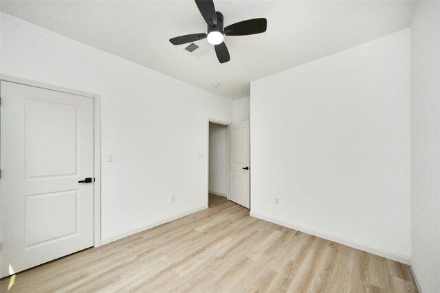 600 Rd 5105, Cleveland, TX 77327 - unfurnished bedroom featuring a ceiling fan, baseboards, visible vents, and wood finished floors
