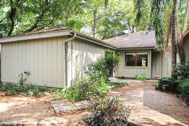view of home's exterior with roof with shingles