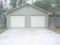 garage featuring concrete driveway
