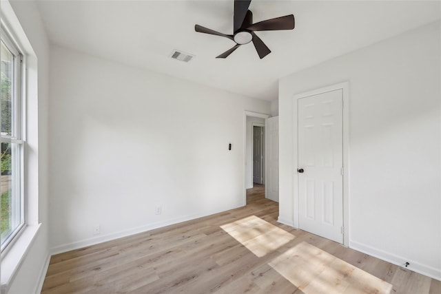 interior space featuring visible vents, multiple windows, and light wood-style flooring