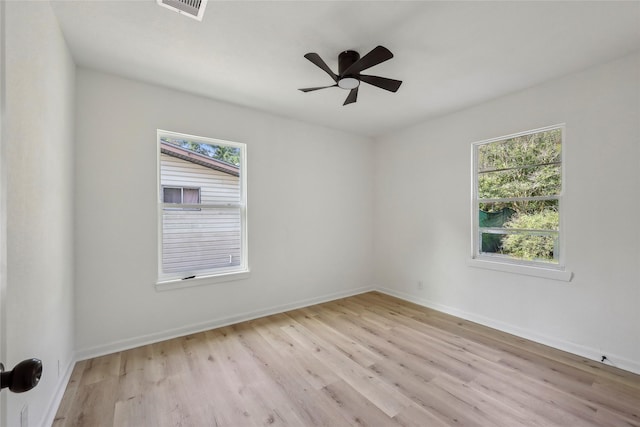 unfurnished room with light wood-style floors, baseboards, ceiling fan, and visible vents