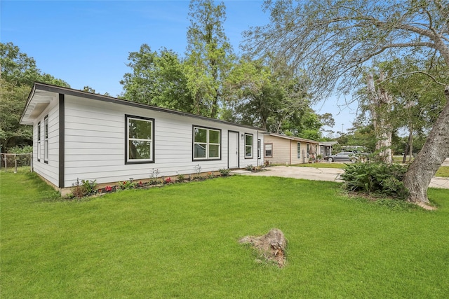 rear view of property featuring a lawn