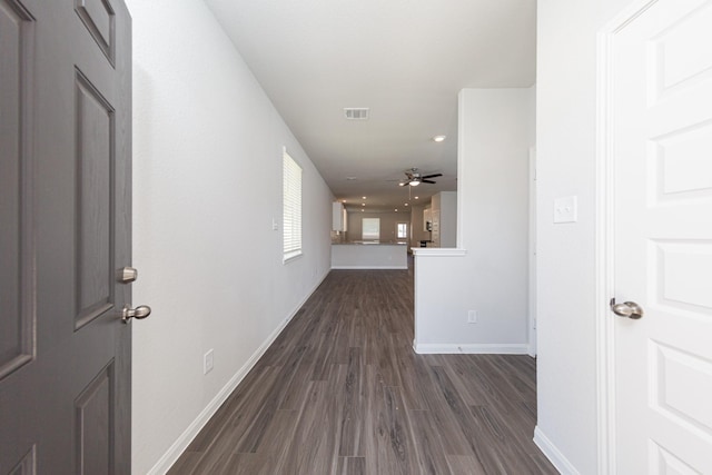 hall with baseboards, recessed lighting, and dark wood-style flooring