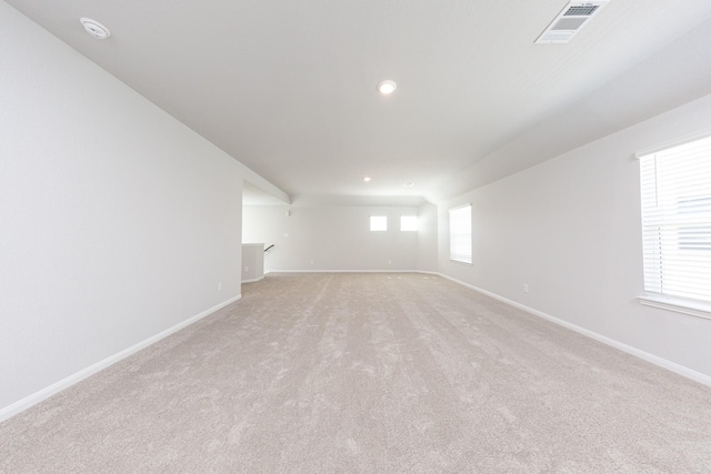 spare room featuring baseboards, light colored carpet, recessed lighting, and visible vents