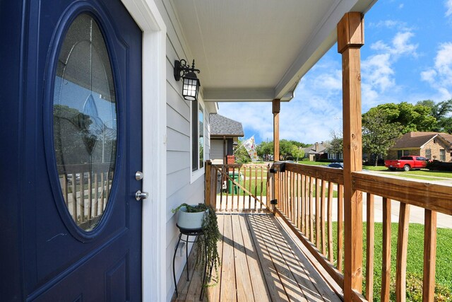 wooden deck with covered porch and a residential view