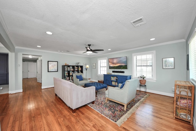 living area with baseboards, recessed lighting, wood finished floors, and visible vents