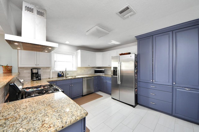 kitchen with a sink, stainless steel appliances, decorative backsplash, island exhaust hood, and visible vents
