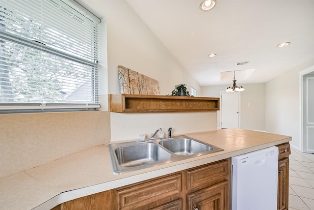 kitchen featuring visible vents, dishwasher, a sink, light countertops, and light tile patterned flooring