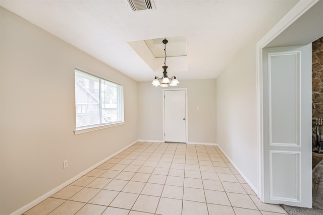 spare room featuring light tile patterned flooring, baseboards, visible vents, and an inviting chandelier