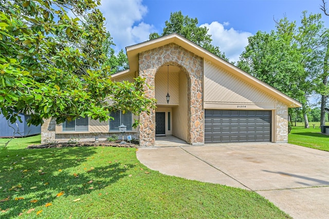 view of front of house with a garage, driveway, a front lawn, and stone siding