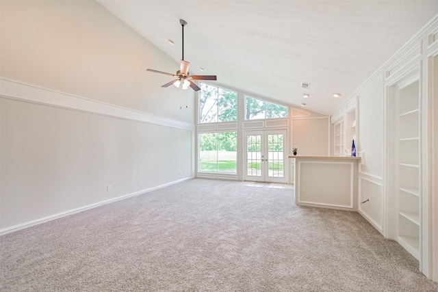 unfurnished living room featuring french doors, a ceiling fan, carpet floors, and high vaulted ceiling