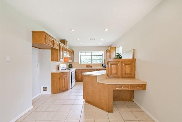kitchen with light countertops, light tile patterned floors, white range with gas cooktop, and visible vents