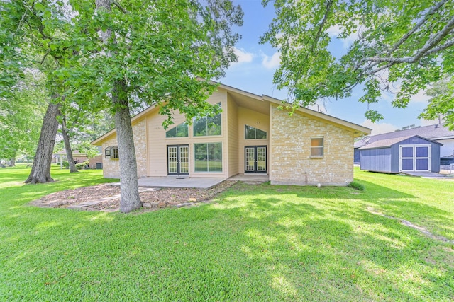 rear view of property with french doors, an outdoor structure, a lawn, and a shed