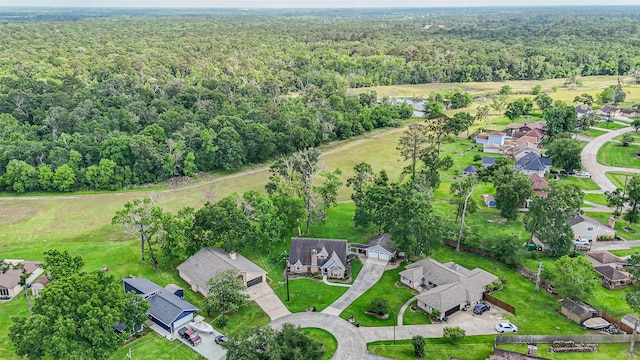 aerial view featuring a forest view and a residential view