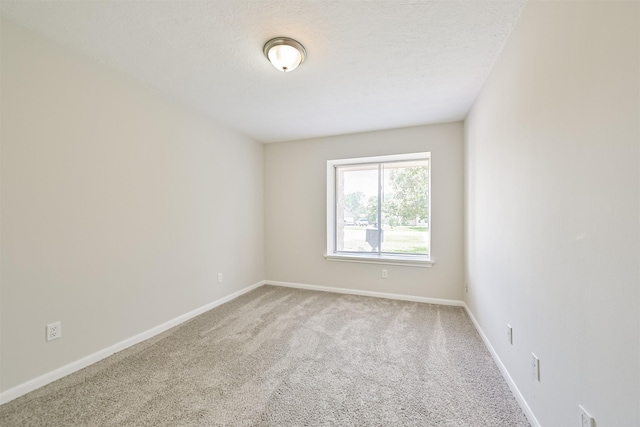 empty room with baseboards and carpet